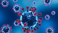 Foto com fundo azul mostrando vírus da covid-19 que são microesferas com lanças fixadas nelas.