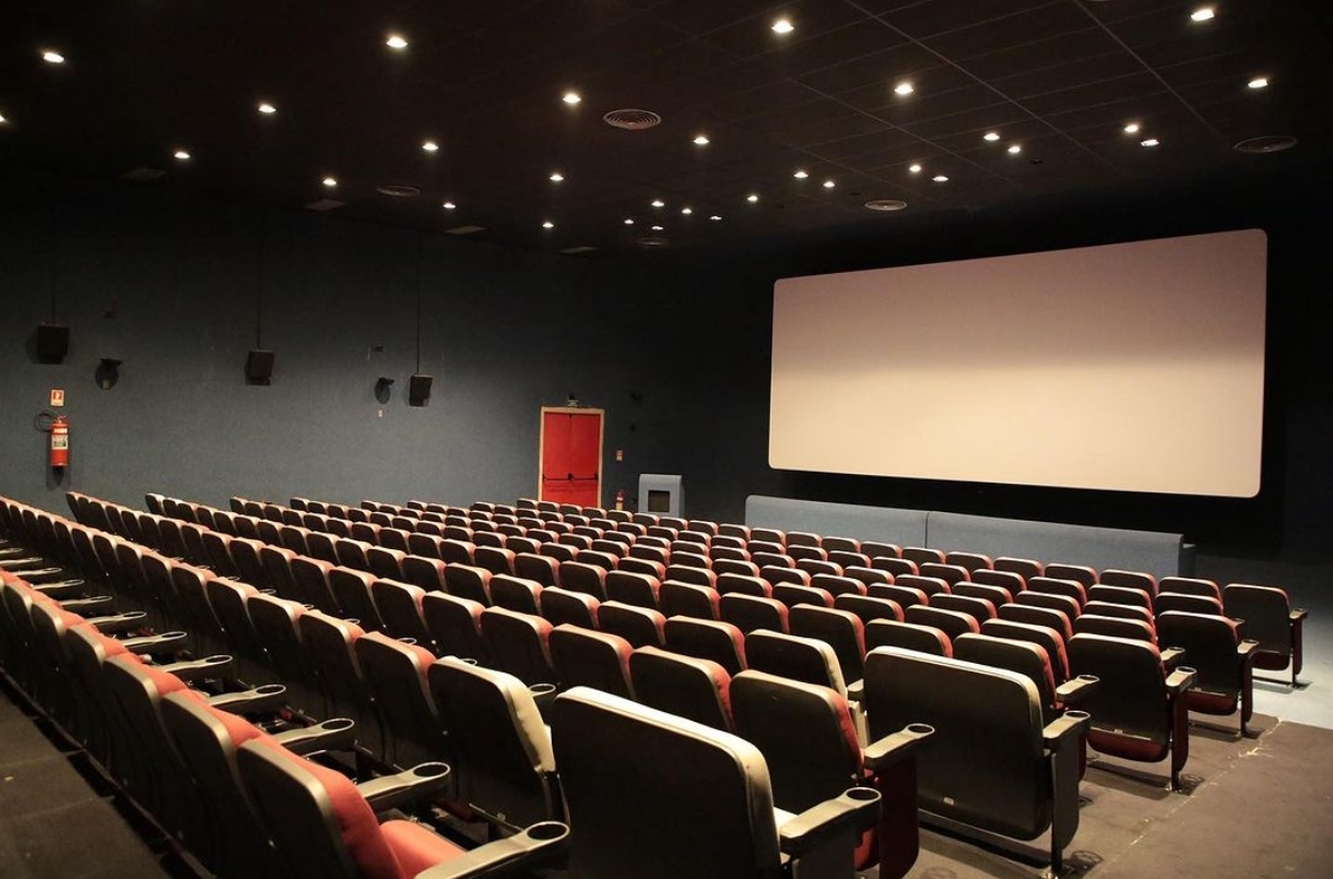 Foto da sala de cinema mostrando as cadeiras e a tela