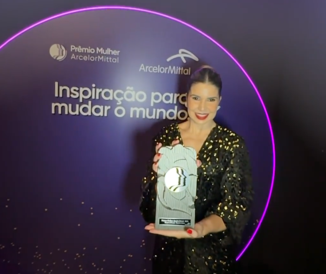 Foto da médica Júlia Polido com o prêmio recebido