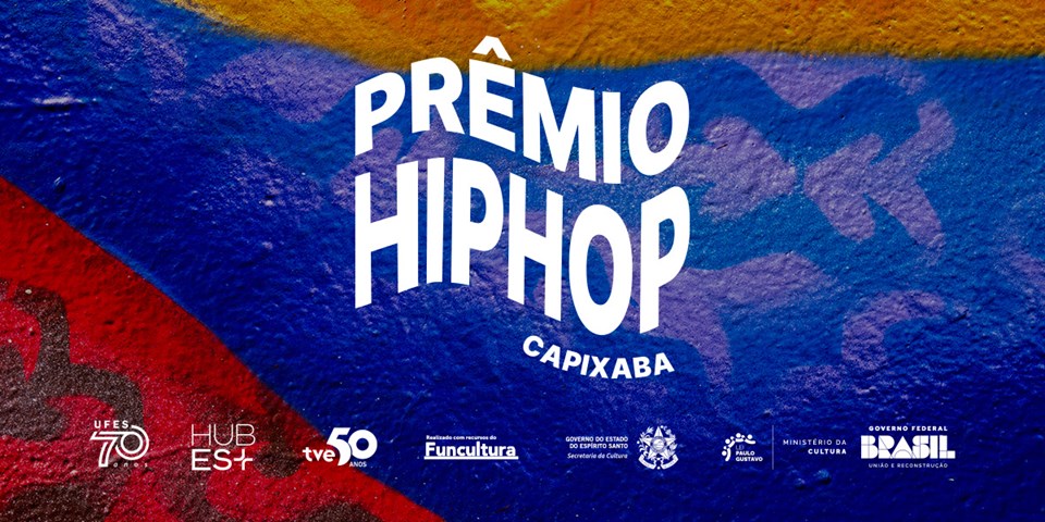 Cartaz de divulgação com as cores vermelho, azul e laranja e, escrito em branco, Prêmio Hip Hop Capixaba.