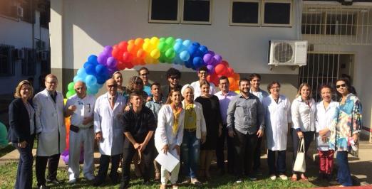 Foto da equipe e de pacientes em frente ao prédio do ambulatório