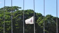 Foto da bandeira da Ufes hasteada a meio mastro