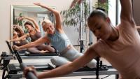 Foto de três mulheres fazendo aula de Pilates