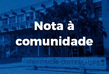 Cartaz com a inscrição Nota à comunidade e uma foto da reitoria ao fundo em tons de azul
